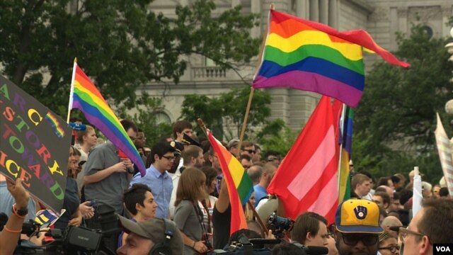 People wave flags, and banners in celebration of the Supreme Court's ruling on Same Sex Marriage in Washington, D.C., June 26, 2015. (Photo: M. Burke / VOA)