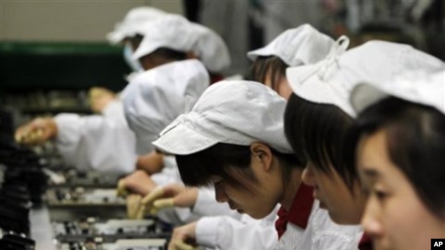 Staff members work on the production line at the Foxconn complex in the southern Chinese city of Shenzhen, Southern city in China, May 26, 2010
