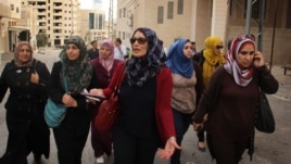 Maysoun Qawasmi and her supporters walk through a town in the West Bank ahead of the Palestinian elections. (VOA / R. Collard)
