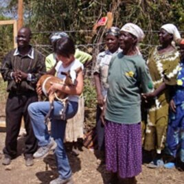B1G1 founder, Masami Sato (C) holds a goat donated through her company at the World Youth International Mama Ann Odede Complex in western Kenya (File)