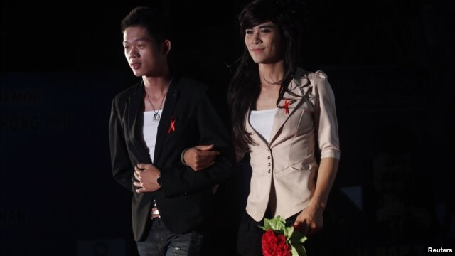 Members of the MSM (Men who have Sex with Men) Club wear red ribbons while they perform at a HIV/Aids awareness campaign in Hanoi, November 27, 2011. 