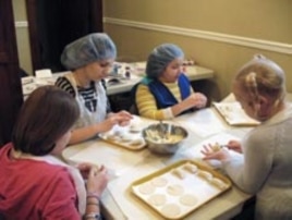 Even the youngest members of the kids' table can shape circles of homemade dough into traditional potato pierogies.