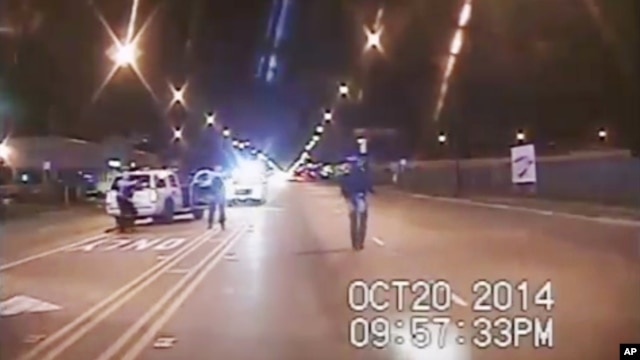 A frame grab from dash-cam video provided by the Chicago Police Department shows Laquan McDonald (R) walks down the street moments before being shot by officer Jason Van Dyke on Oct. 20, 2014.