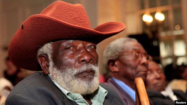 Njenga Kiarie, a Mau Mau War Veterans Association member, follows proceedings during news conference, Nairobi, June 6, 2013.