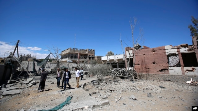 FILE - Yemeni people inspect the damage after an airstrike by Saudi-led coalition in Sana'a, Yemen, Saturday, Feb. 27, 2016. 