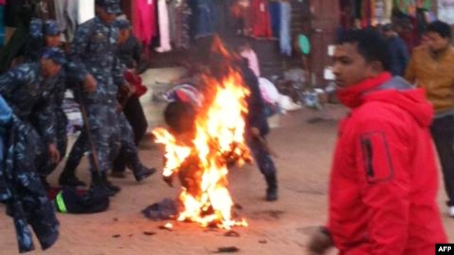 An exiled Tibetan monk sets himself on fire at Boudhanath Stupa in Kathmandu, February 13, 2013.