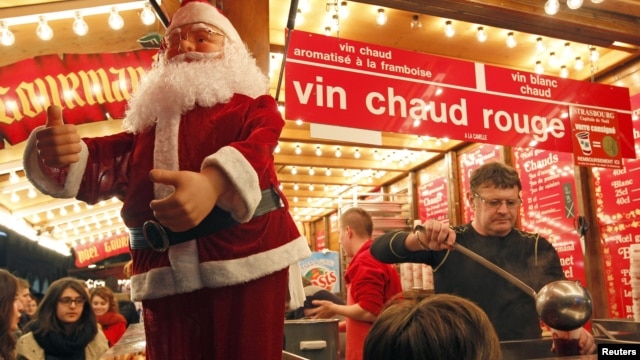 A vendor serves hot wine at the traditional Christkindelsmaerik (Christ Child market) near Strasbourg Cathedral. Nov. 24, 2012. 