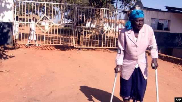 FILE - Malawi’s longest-serving witchcraft prisoner Ezereti Kampota walks to freedom from Maula Maximum Security Prison, in Lilongwe after the Association of Secular Humanism and its Executive Director George Thindwa became advocates for her release, May 31, 2011.