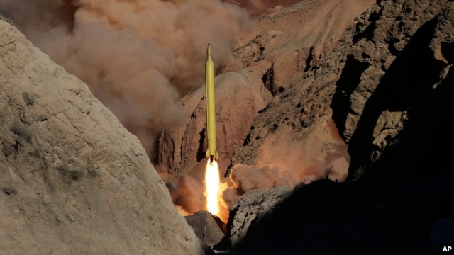 In this photo obtained from the Iranian Fars News Agency, a Qadr H long-range ballistic surface-to-surface missile is fired by Iran's Revolutionary Guard, during a maneuver, in an undisclosed location in Iran, Wednesday, March 9, 2016.