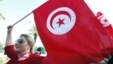 A woman waves a Tunisia flag during a rally to protest against religious and political violence in Tunis, Oct. 22, 2012. 