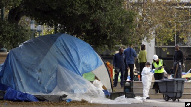 Oakland public works employees survey and clean up Frank Ogawa plaza Monday, Nov. 14, 2011 in Oakland, Calif. The Occupy encampment was evicted from the plaza early this morning.