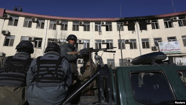 Afghan police keep watch near the Kabul traffic police headquarters that was attacked by insurgents, in Kabul, Afghanistan, January 21, 2013.