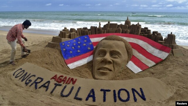 Patnaik, an Indian artist gives finishing touches to a sand sculpture of U.S. President Obama on a beach in Puri, India.
