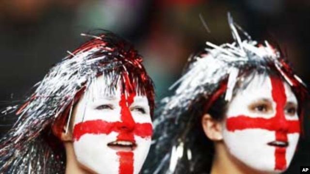 Two young England football supporters, their faces painted with the St George's Cross, at a World Cup qualifying match in London in 2009