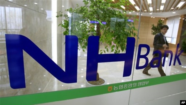 A customer leaves a branch of the Nonghyup bank in Seoul, South Korea,May 3, 2011.