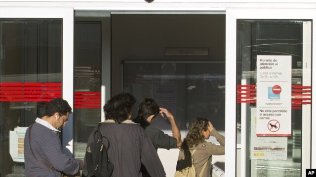People enter an unemployment registration office in Madrid, September 4, 2012. 