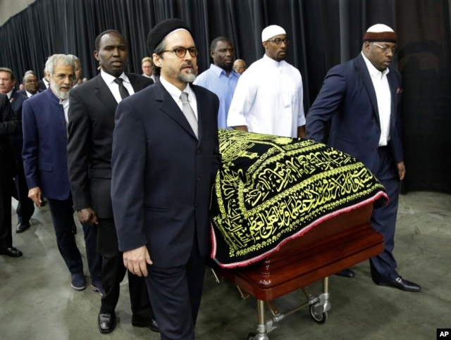 Muhammad Ali's casket is escorted by pallbearers for his Jenazah, a traditional Muslim service, at Freedom Hall in Louisville, Ky., June 9, 2016.