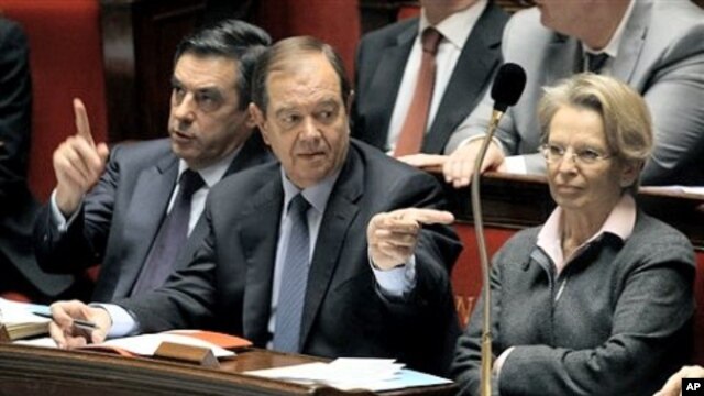 French PM Francois Fillon, left, with Parliamentary Relations Minister Patrick Ollier, centre, his partner Foreign Affairs Minister, Michele Alliot-Marie during the government questions at the French Parliament in Paris, February 9, 2011.
