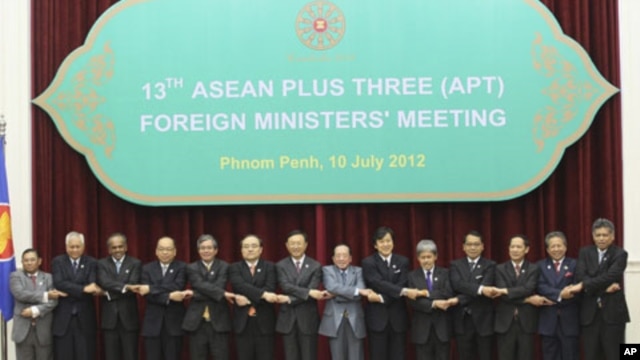 ASEAN countries' foreign ministers join their hands during a photo session at the 45th Association of Southeast Asian Nations (ASEAN) Foreign Ministers' Plus three Meeting in Phnom Penh, Cambodia, Tuesday, July 10, 2012. 