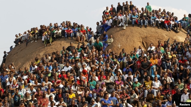 Mining community gathers at a hill dubbed the 'Hill of Horror' during a memorial service for miners killed during clashes at Lonmin's Marikana platinum mine in Rustenburg, 100 kilometers northwest of Johannesburg, South Africa, August 23, 2012.