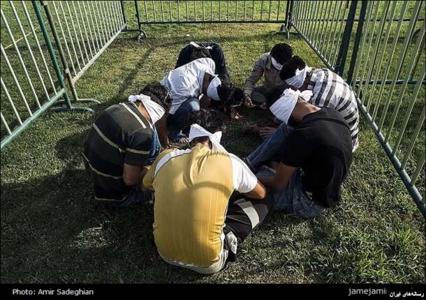 The Afghan government is protesting Iran's decision to blindfold several Afghans and put them in cages.