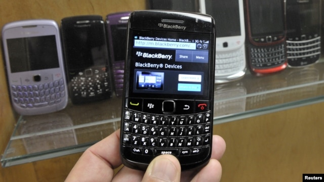 A BlackBerry device is shown in front of products displayed in a glass cabinet at the Research in Motion offices in Waterloo November 14, 2012.