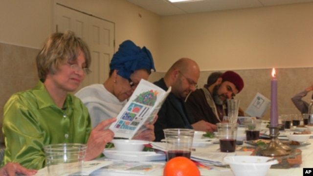 Andrea Barron (left) and Rizwan Jaka (second from right) join others in  reading from the Haggadah, a Jewish text which outlines the order of the Passover Seder.