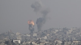 An explosion and smoke are seen after an Israeli strike in Gaza November 15