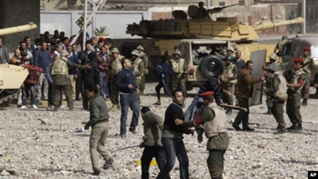 Pro-government supporters are restrained by soldiers just outside Cairo's main square, Feb. 3, 2011