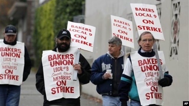 A small group of picketers from Bakery and Confectioners Workers Union Local 9 walk past a closed Hostess plant, Seattle, Nov. 16, 2012.