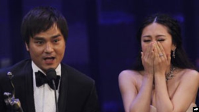 Actress JJ Jia, right, and producer Gordon Lam celebrates after winning the Best Film award for the movie 'Gallants' at the Hong Kong Film Awards in Hong Kong, Sunday, April 17, 2011.