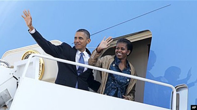 President Barack Obama and first lady Michelle Obama waves as they board Air Force One at Andrews Air Force Base, MD as they begin their trip to Asia. The president will visit India, Indonesia, South Korea, and Japan, 5 Nov 2010