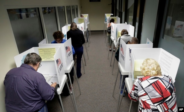 Voters cast ballots at the Santa Clara County Registrar of Voters in San Jose, Calif., Oct. 24, 2016.