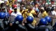 Students throw stones against riot police officers during their protest against university tuition hikes outside the union building in Pretoria, South Africa, Oct. 23, 2015. 