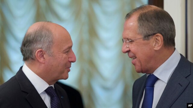 Russian Foreign Minister Sergey Lavrov, right, greets his French counterpart Laurent Fabius prior to their meeting in Moscow, Sept. 17, 2013.