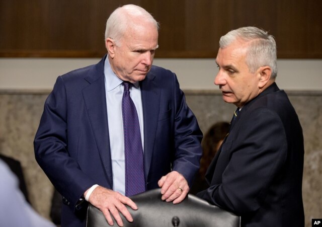 Senate Armed Service Committee Chairman John McCain, R-Ariz., left, talks with committee's ranking member Jack Reed, D-R.I., on Capitol Hill in Washington, July 29, 2015.