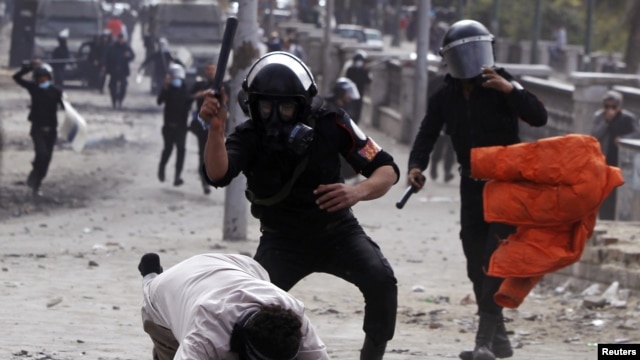Polisi anti huru-hara Mesir memukuli seorang demonstran anti pemerintah di Kairo (28/1). HRW menilai pergolakan di Jazirah Arab telah membuka jalan bagi pemerintahan baru yang tidak menghormati HAM.