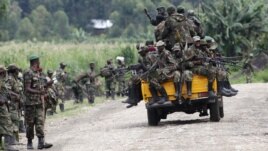 M23 rebel fighters sit on a truck as they prepare to withdraw near the town of Sake, 42 kilometers west of Goma in eastern Congo, November 30, 2012.