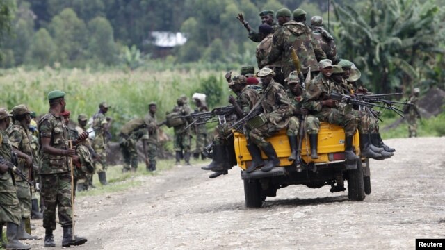 M23 rebel fighters sit on a truck as they prepare to withdraw near the town of Sake, 42 kilometers west of Goma in eastern Congo, November 30, 2012.