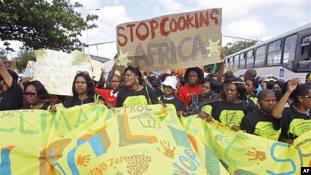 Protesters march during a climate change rally outside a climate change summit held in the city of Durban, South Africa, Friday, Dec 2, 2011. (AP Photo/Schalk van Zuydam)