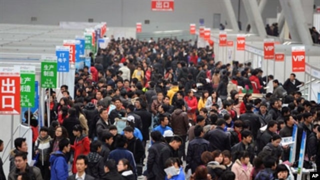 Chinese jobseekers check out the various vacancies offered at a job fair.  Premier Wen Jiabao said China had set a lower than usual economic growth target and pledged to contain soaring prices, February 26, 2011