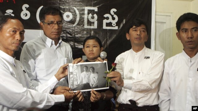 Burma's prominent student leader, Min Ko Naing, second from right, senior leader, Ko Ko Gyi, left, and other members hold a picture of recently detained student activists in Rangoon, Burma, July. 7, 2012.