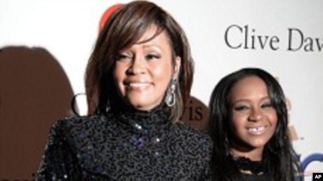 FILE - Whitney Houston and daughter Bobbi Kristina in Beverly Hills, California.