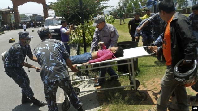Unidentified survivor of a plane crash is carried for treatment to a nearby city of Pokhara, Nepal. The plane crashed into a mountain in the Himalayas while trying to land at an airport in northern Nepa killing 15 people and critically injuring six.