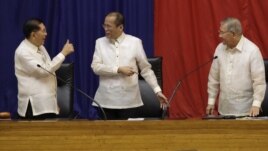 Philippine President Benigno Aquino III, center, is given a thumbs-up sign by Senate President Juan Ponce Enrile, left, while House Speaker Feliciano Belmonte looks on, after he delivers his third State of the Nation address Monday July 23, 2012. 