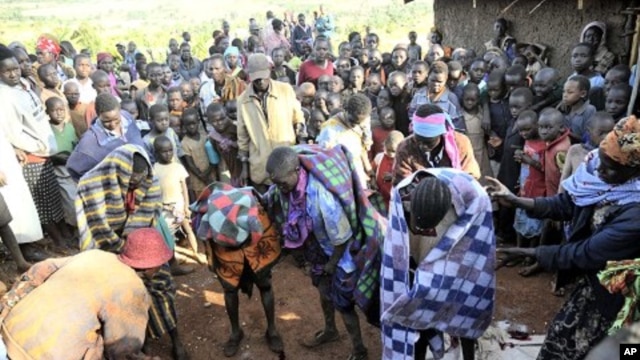 People gather around teenage girls from Uganda's Sebei tribe who have just undergone female genital mutilation near Kampala, Feb. 2011 (file photo).