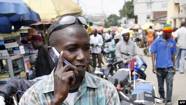 A motorcyclist talks on his cell phone in Obalende, a district of Lagos, August 18, 2008.