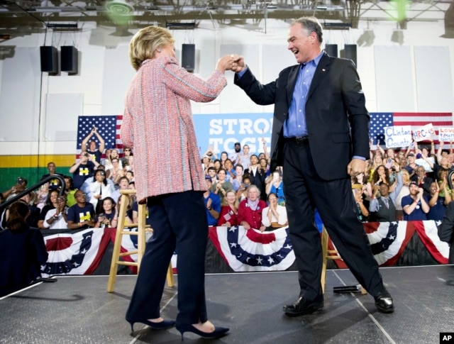 Democratic presidential candidate Hillary Clinton fist bumps Sen. Tim Kaine, D-Va., after speaking at a rally at Northern Virginia Community College in Annandale, Thursday, July 14, 2016.