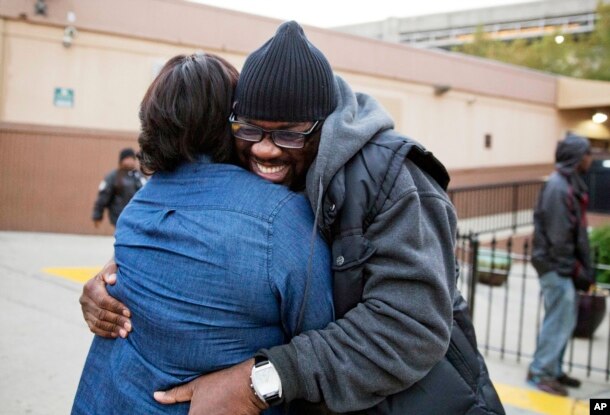 Darryl Hamlett embraces his fiancee, Beverly Conners, as he arrives off a bus from New York to spend the Thanksgiving holiday in Atlanta, Nov. 23, 2016.