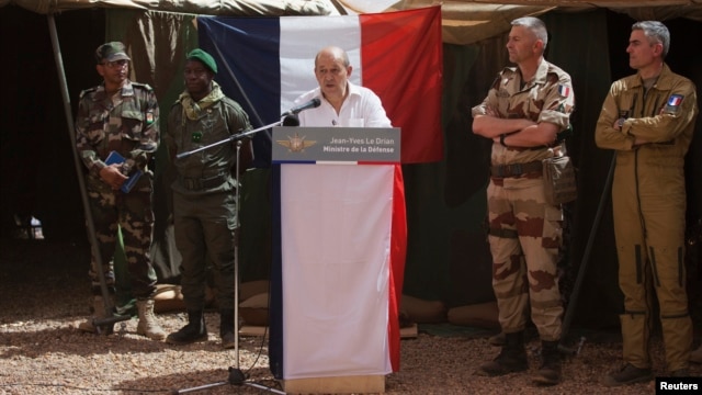 French Defense Minister Jean-Yves Le Drian addressing troops at a military encampment at a Malian air base, Gao, March 7, 2013.